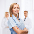 © Syda Productions - smiling female doctor or nurse