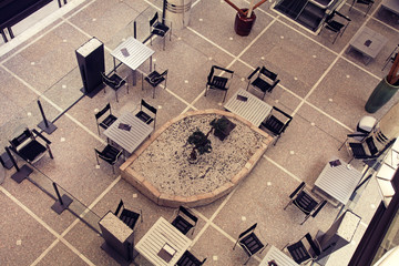 Tables and chairs in contemporary cafe, view from above