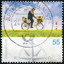 Stamp Printed By Germany, Shows Postman On Bicycle