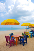 Colorful Chair And Table With Yellow Umbrella On The Beach