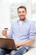 © Syda Productions - smiling man working with laptop and credit card