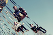 Teenage girls on the chain swing carousel
