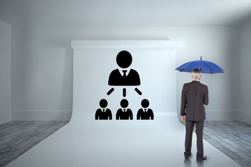 Poster - Composite image of businessman holding umbrella