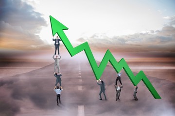 Poster - Composite image of business team holding up arrow
