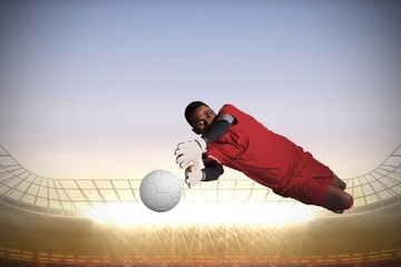 Aufkleber - Composite image of goalkeeper in red making a save