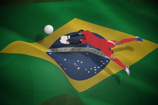 Composite image of goalkeeper in red making a save
