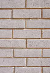 Poster - Wall of white bricks with yellow fugue