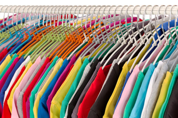 Wall Mural - Colored shirts on hangers steel closeup.