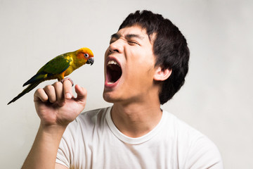 Wall Mural - Asian men with parrot - Sun Conure