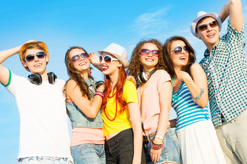 Wall Mural - group of young people wearing sunglasses and hat