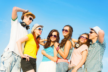 Wall Mural - group of young people wearing sunglasses and hat