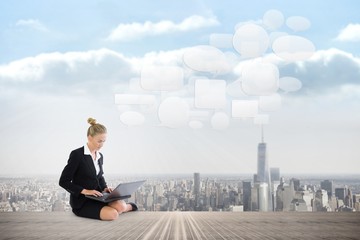 Poster - Composite image of businesswoman using laptop