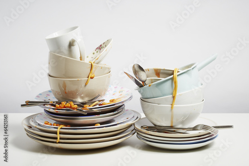 Fotografie, Obraz Dirty dishes pile needing washing up on white background