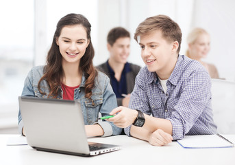 Wall Mural - students with laptop and notebooks at school
