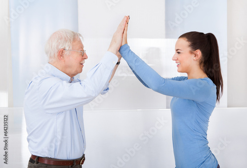 Fotografía Caregiver And Senior Man Giving High Five