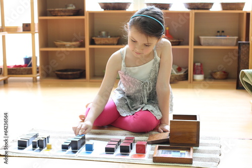 Girl playing with trinomial cube blocks