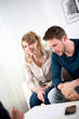 © W PRODUCTION - cheerful young couple with salesman at home
