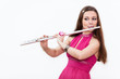 Woman musician in red dress playing flute, on white background