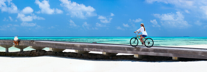 Canvas Print - Young woman biking