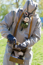 Human In Protective Suit And Gas Mask Making Analyzes