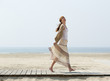 Carefree middle aged woman walking barefoot