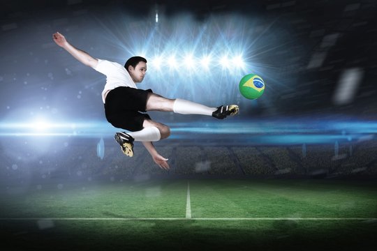 Composite image of football player in white kicking