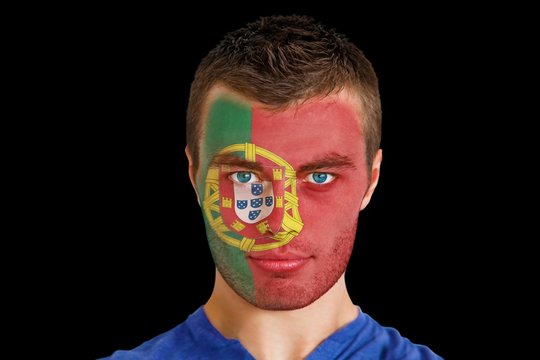 Composite image of serious young portugal fan with facepaint