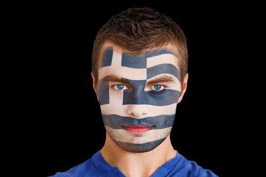 Composite image of serious young greece fan with facepaint