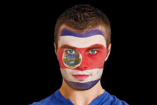 Composite image of serious young costa rica fan with facepaint