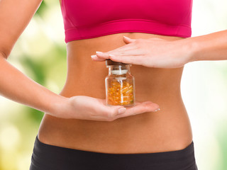 Wall Mural - close up of female hands with bottle of capsules