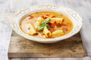 Canvas Print - Vegetable soup in ceramic plate standing on wooden table