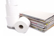 toilet paper and stack of magazines