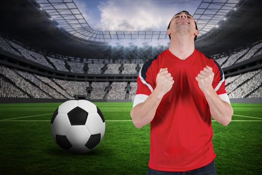 Composite image of excited football fan cheering