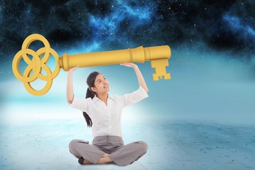Poster - Composite image of businesswoman sitting cross legged carrying l