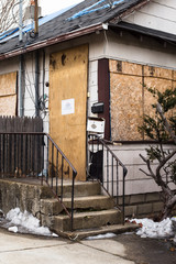 boarded up condemned home in foreclosure