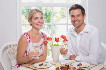 Wall Mural - Happy young couple with wine glasses having food