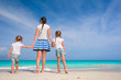 © travnikovstudio - Young happy mother and her adorable daughters having fun at