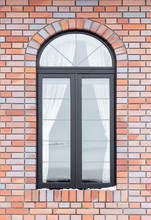 Painted Wood Arched Window In A Red Brick Wall