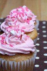 Three Cupcakes with Pink Icing and Sprinkles