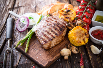 Beef steak on wooden table