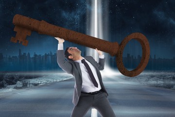 Poster - Composite image of unsmiling businessman carrying large key