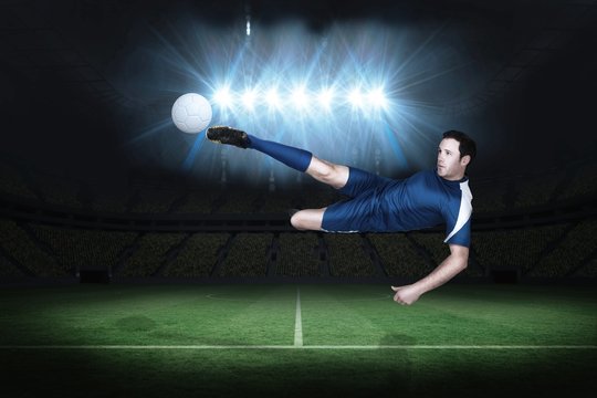 Composite image of football player in blue kicking