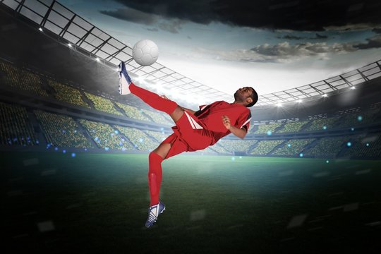 Football player in red kicking