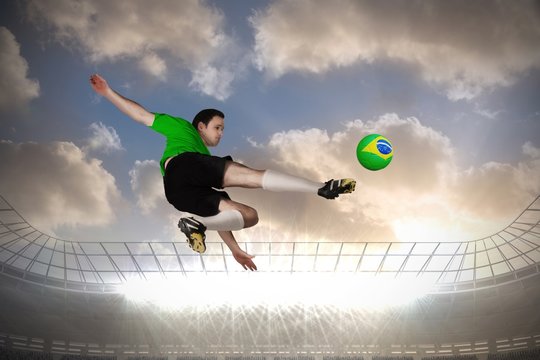 Football player in green kicking