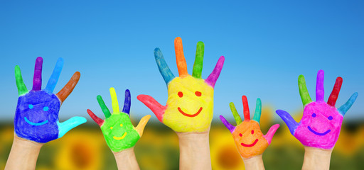 Smiling hands on summer background