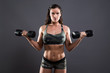 © ysbrandcosijn - Fitness woman weight lifting with dumbbells. Wearing camouflage