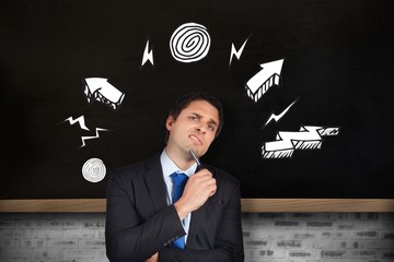 Poster - Composite image of thinking businessman holding pen