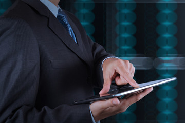 businessman hand using tablet computer and server room backgroun