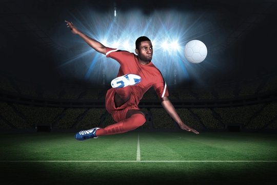 Football player in red kicking