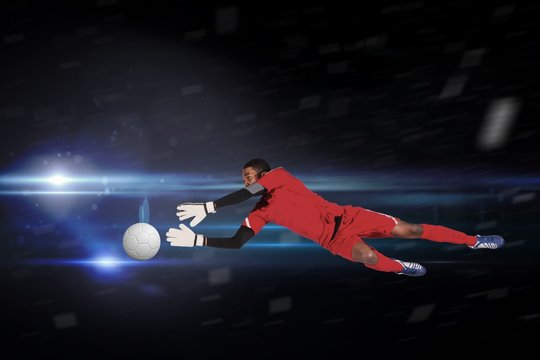 Goalkeeper in red making a save